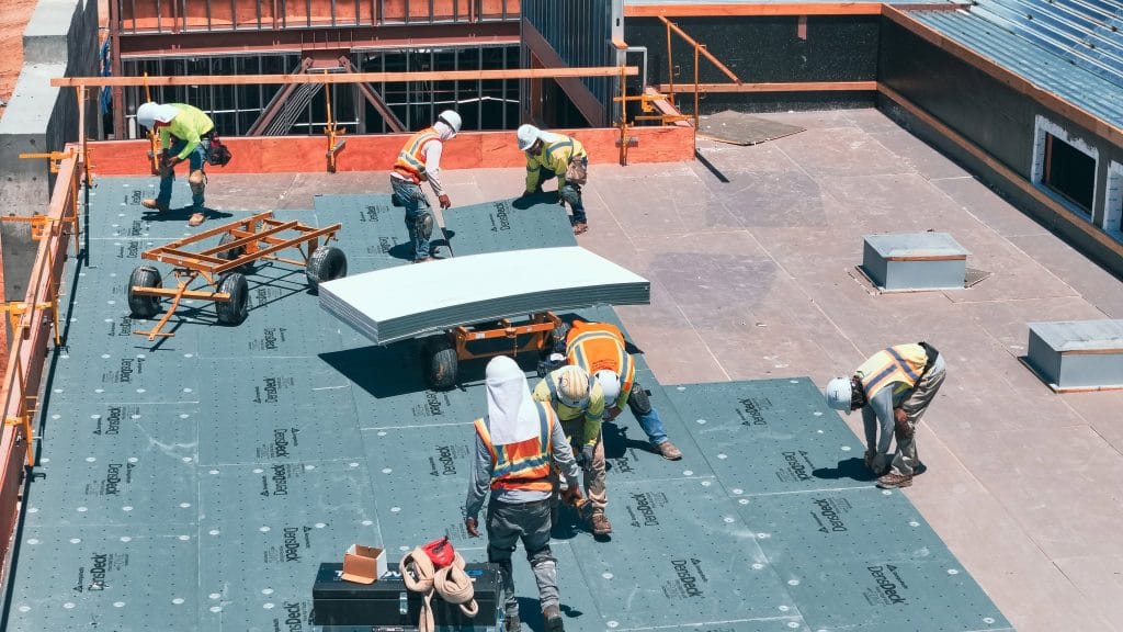team of Roofs Inc doing commercial roof replacement