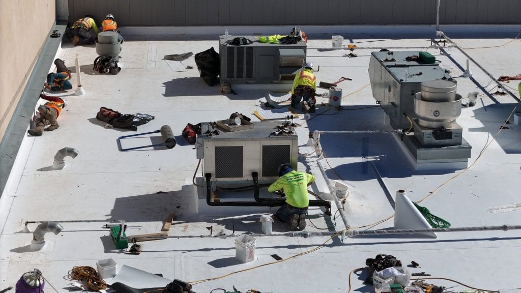 roofs inc team working on commercial roof